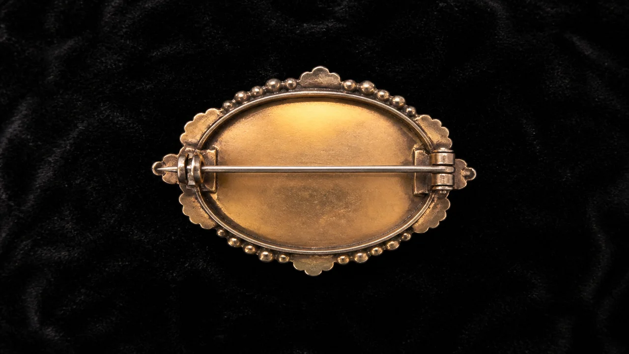 Front and back views of brooches showing pin hinges, catches, motifs, and maker marks